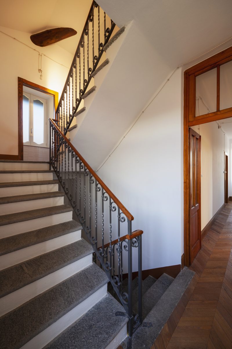 Staircase in rock of an ancient villa with white walls. Nobody inside