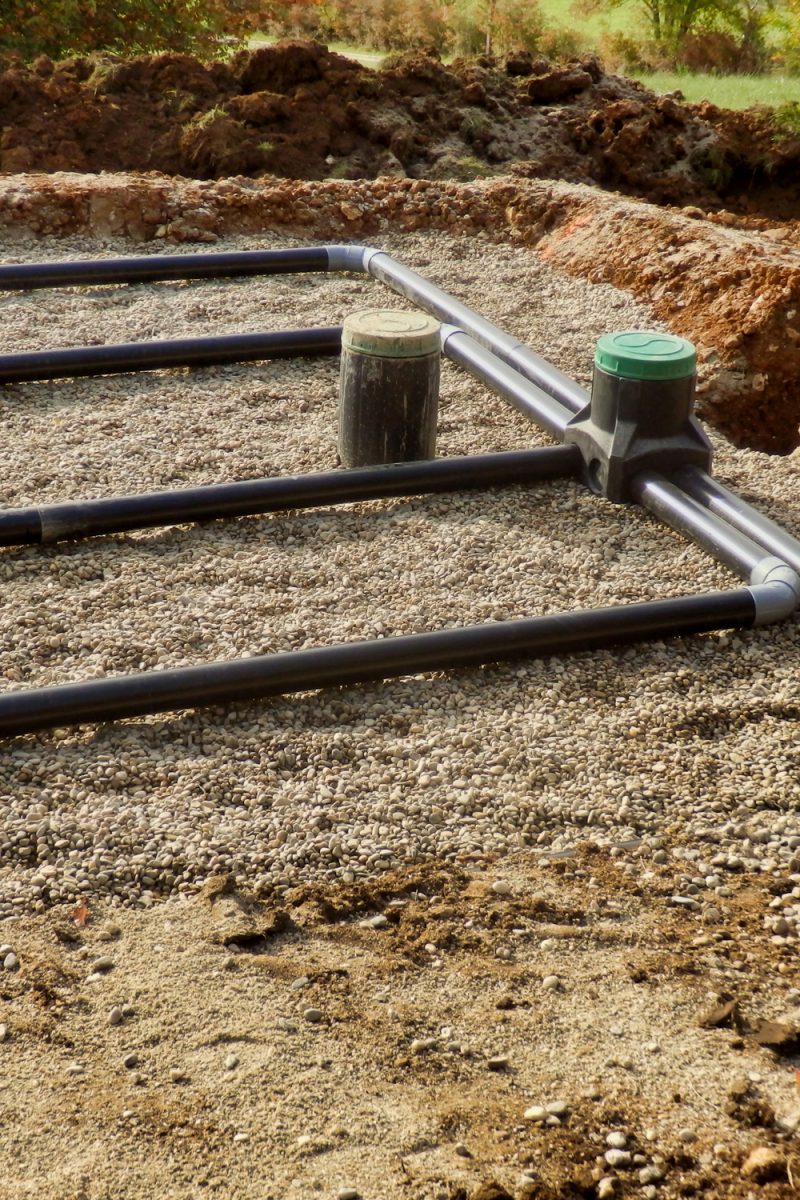 The top layer of pipework, after the membrane, sand and gravel had been applied, during the construction of a sand and gravel drainage system