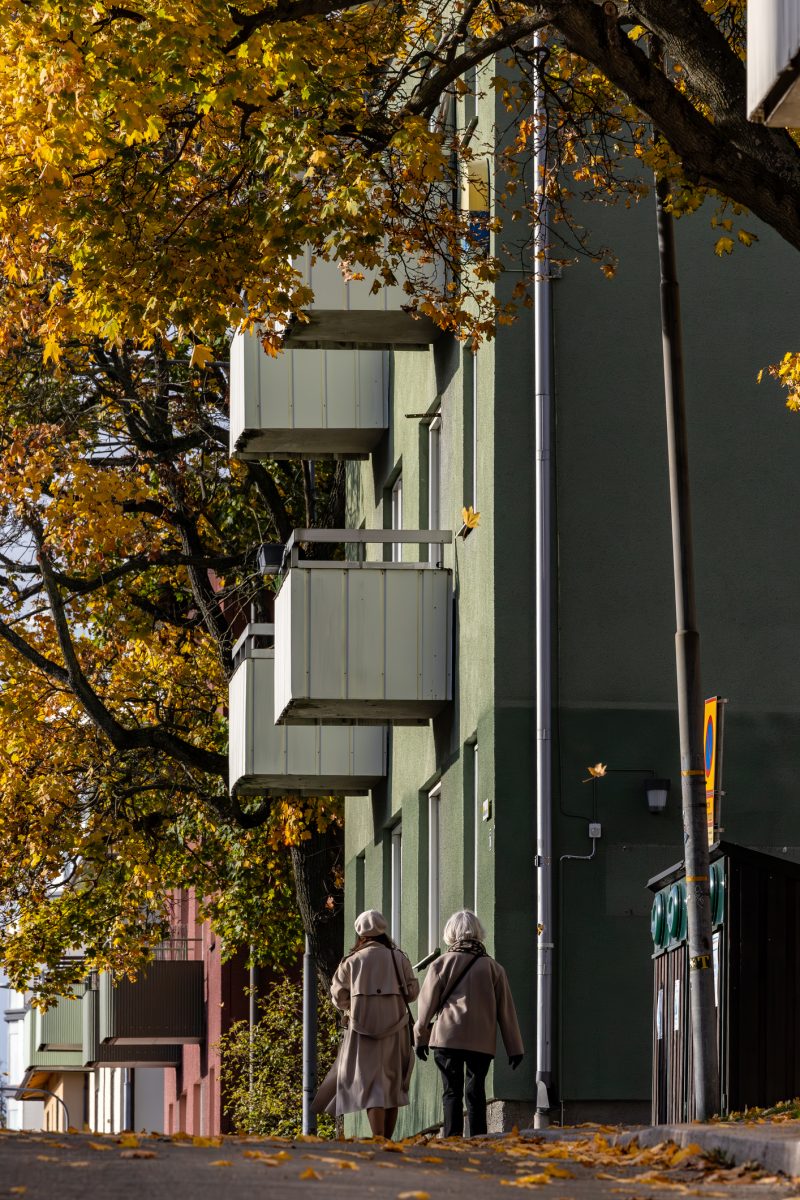 Stockholm, Sweden Oct 19, 2024 Two senior women walk on a wooded street in the Solna suburb in the autumn.